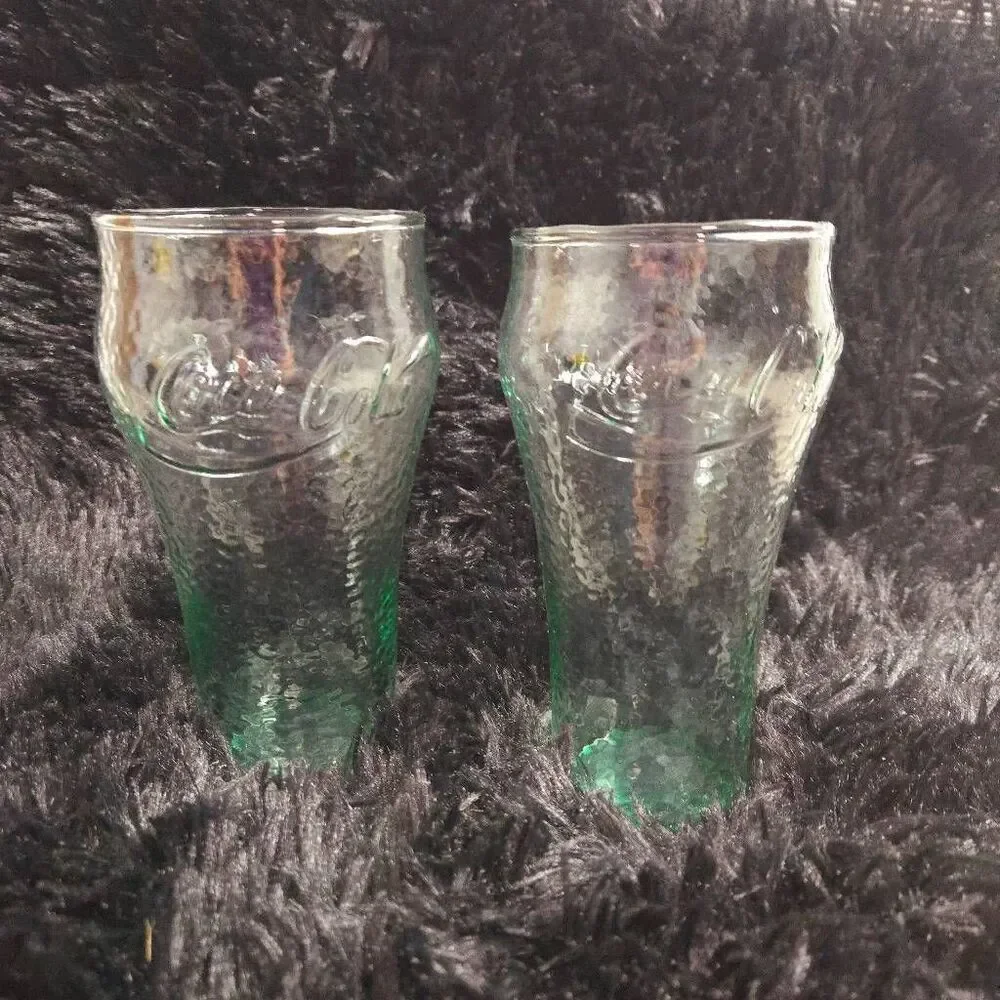 2 vintage Coca-Cola glasses with a green tint and a textured surface, often call